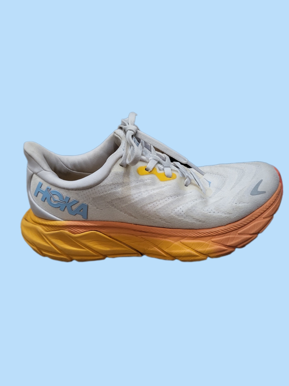 Hoka White Running Shoe with Yellow and Orange Midsole